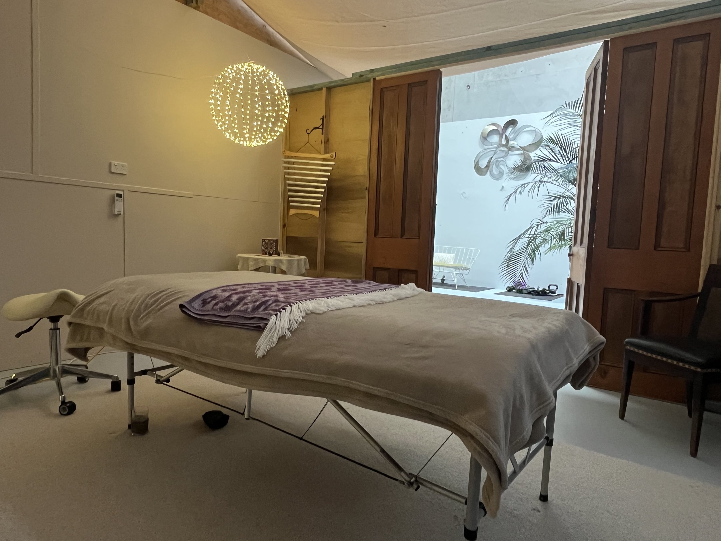 Vicki Jacobsen\'s peaceful craniosacral treatment room with warm lighting