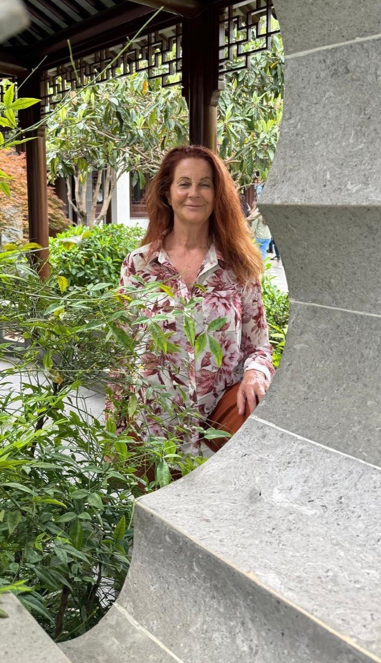 Vicki Jacobsen in a peaceful garden courtyard setting